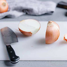 Sturdy plastic cutting board for reliable kitchen use.