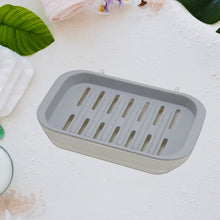 Water-draining soap holder with adhesive backing for easy use